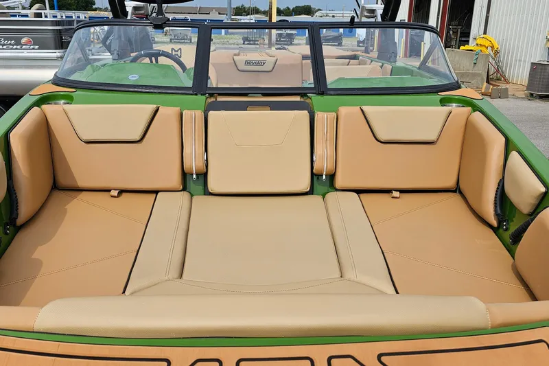 Slide: The Image of 2025 Heyday WTSurf boat interior with tan seating and green accents. - 5