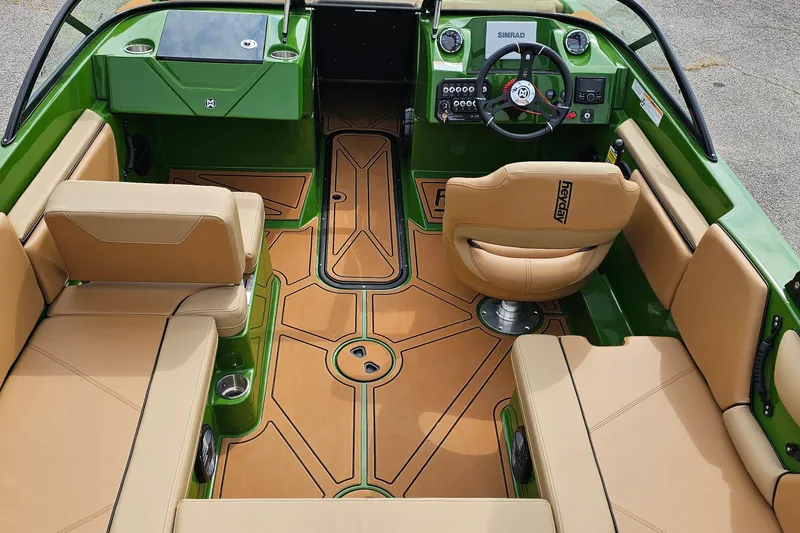 Slide: The Image of 2025 Heyday WTSurf boat interior with green and tan seating, modern dashboard, and stylish flooring. - 6