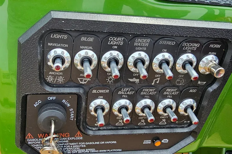 Slide: The Image of Control panel of 2025 Heyday WTSurf boat with various switches and ignition key. - 9