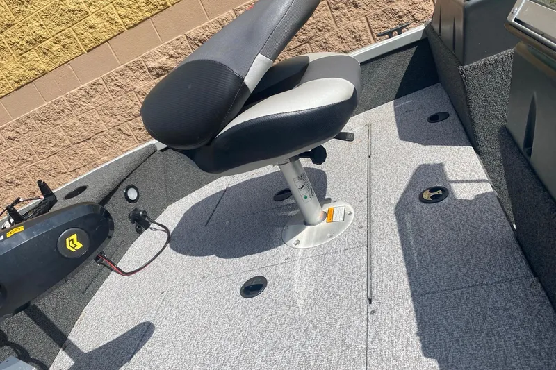 Slide: The Image of 2017 Alumacraft Classic 165 boat interior with swivel seat and carpeted floor. - 6