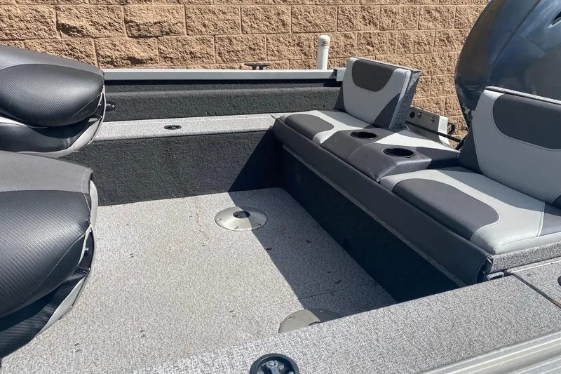 Slide: The Image of 2017 Alumacraft Classic 165 boat interior with gray seating and cup holders. - 7