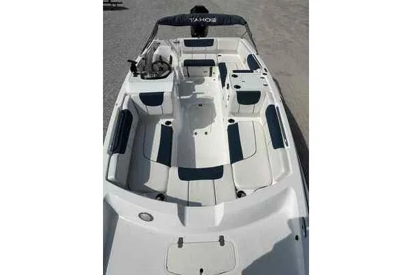 Slide: The Image of 2023 Tahoe 2150 boat interior with white and navy seating, spacious layout. - 2