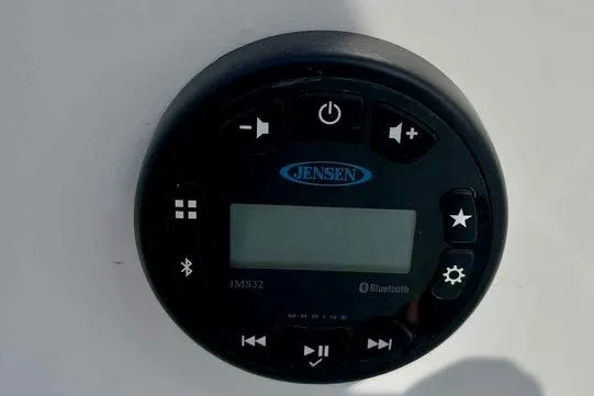 Slide: The Image of Jensen JMS32 Bluetooth stereo system on 2023 Tahoe 2150 boat dashboard. - 7