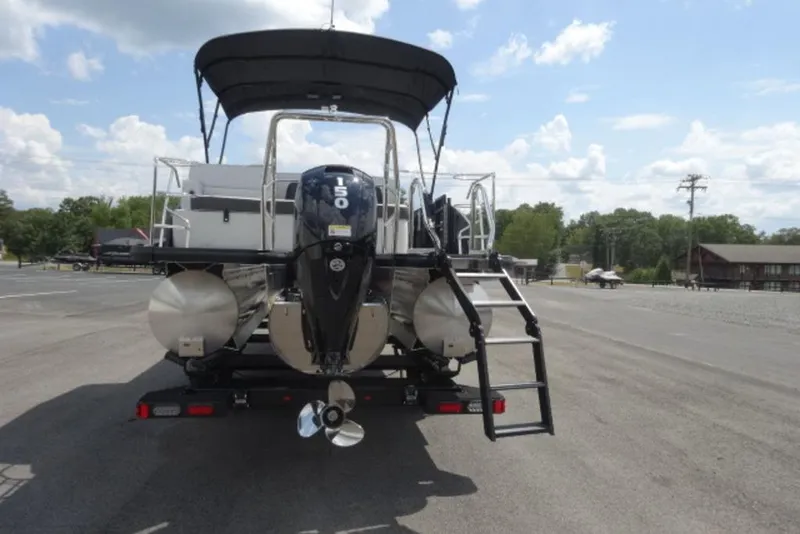 Slide: The Image of 2026 Harris Cruiser 230 Heritage Edition pontoon boat with outboard motor and ladder. - 11