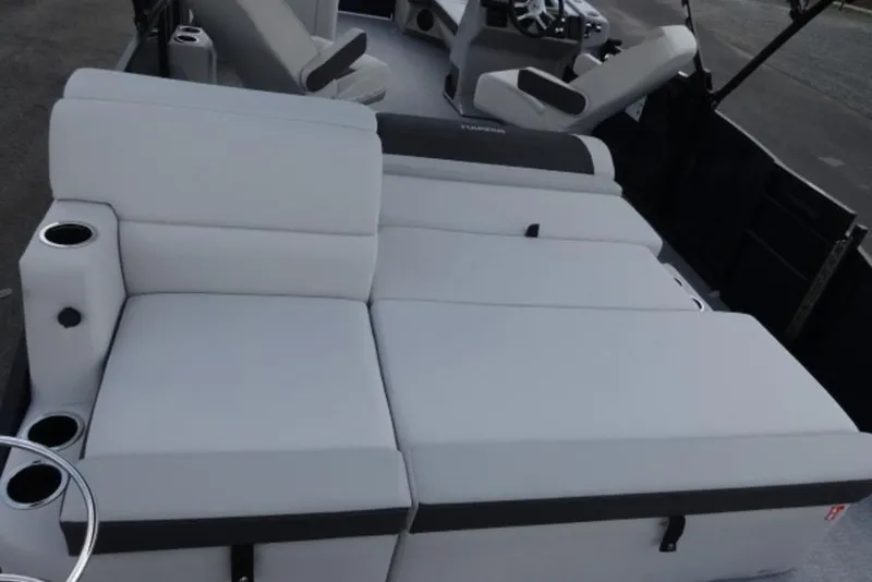 Slide: The Image of 2026 Harris Cruiser 230 Heritage Edition boat interior with white cushioned seating. - 16
