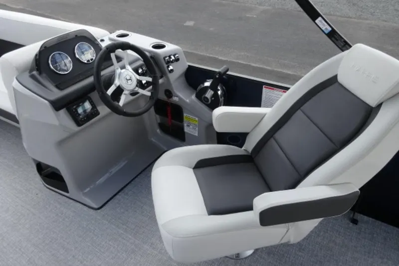 Slide: The Image of 2026 Harris Cruiser 230 Heritage Edition boat interior with steering wheel and captain's chair. - 6