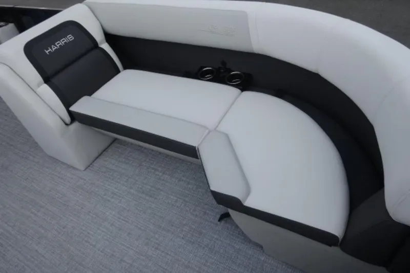 Slide: The Image of 2026 Harris Cruiser 230 Heritage Edition boat seating with cup holders, featuring sleek gray upholstery. - 8