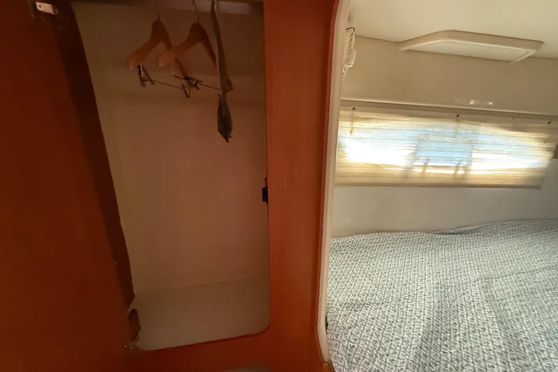 Slide: The Image of Cozy cabin interior of 2010 Leopard 38 with bed and closet space. - 108