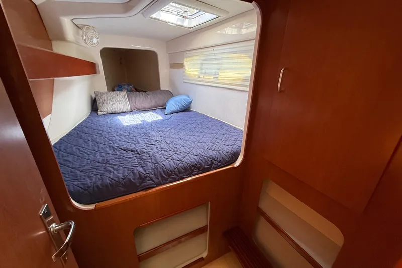 Slide: The Image of Cozy cabin interior of 2010 Leopard 38 yacht with bed and wooden finish. - 110