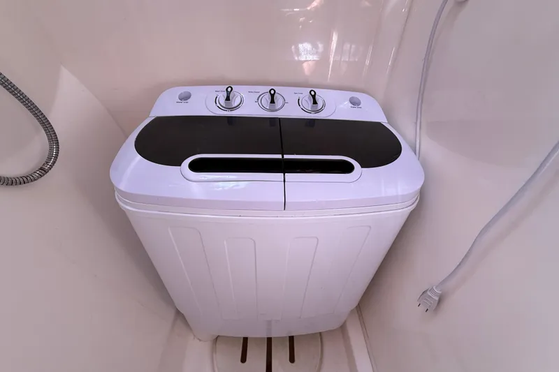 Slide: The Image of Compact washing machine in a Leopard 38 yacht, 2010 model, with control knobs. - 111