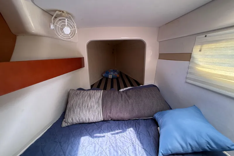 Slide: The Image of Cozy cabin interior of 2010 Leopard 38 catamaran with bed, pillows, and fan. - 113