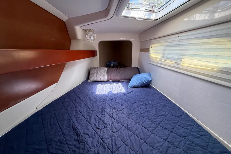 Slide: The Image of Cozy cabin interior of 2010 Leopard 38 yacht with blue bedding and skylight. - 114