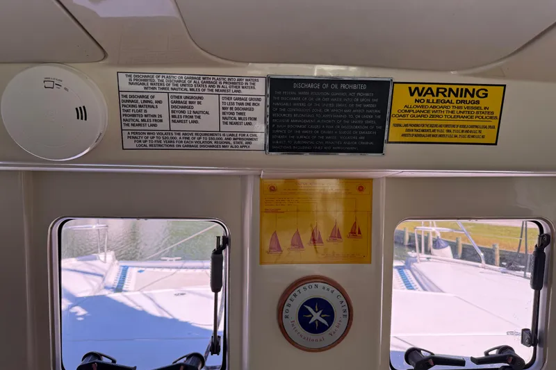 Slide: The Image of Interior of a 2010 Leopard 38 boat with safety and compliance notices. - 115