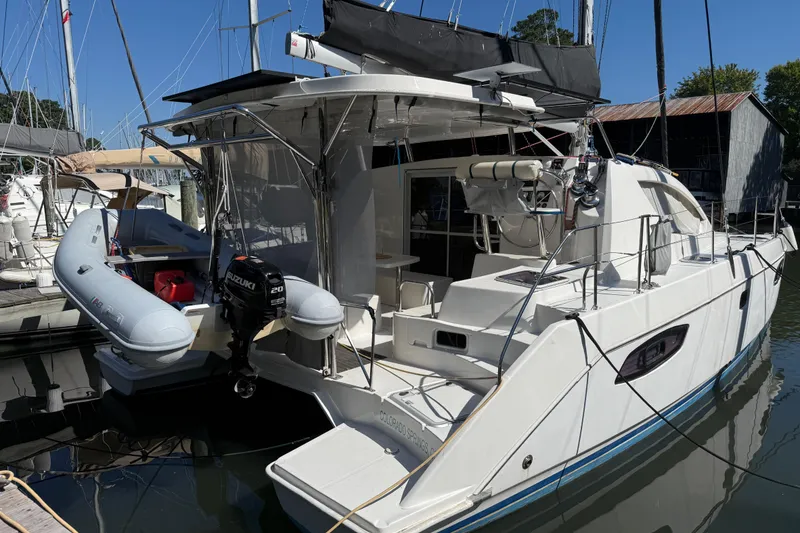 Slide: The Image of 2010 Leopard 38 catamaran docked with inflatable dinghy and Suzuki outboard motor. - 12