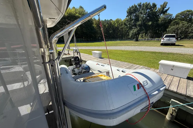 Slide: The Image of Inflatable boat on Leopard 38 yacht, docked near grassy area, 2010 model. - 14