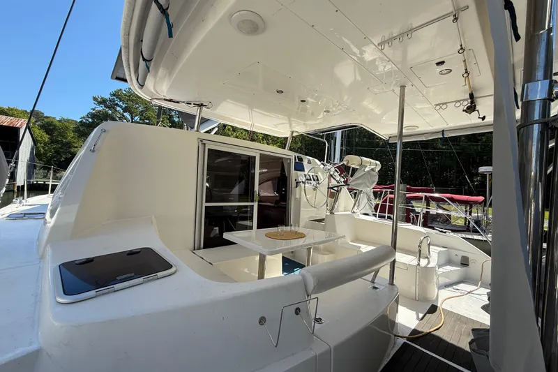 Slide: The Image of 2010 Leopard 38 yacht cockpit with seating, table, and helm station under a canopy. - 16