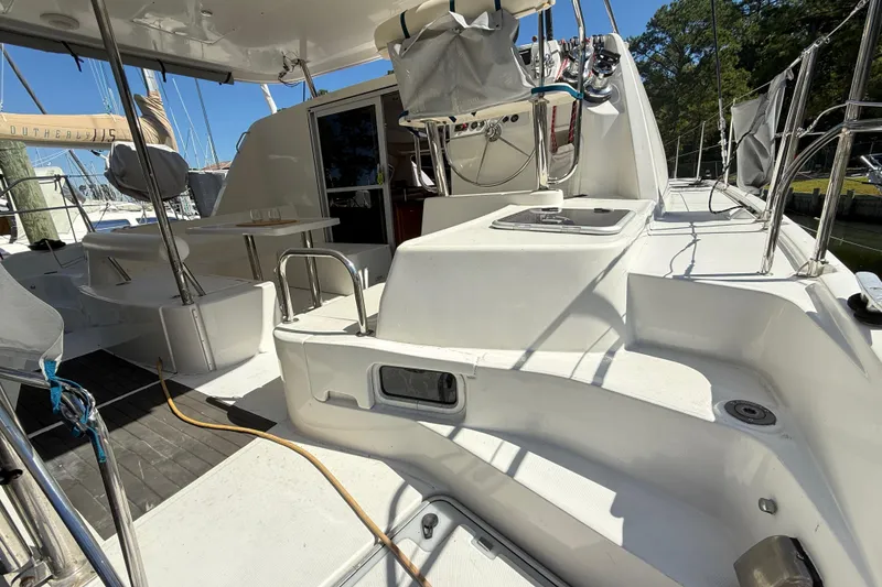 Slide: The Image of 2010 Leopard 38 catamaran cockpit with seating, steering wheel, and outdoor table. - 17