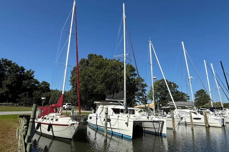 Slide: The Image of 2010 Leopard 38 catamaran docked at marina under clear blue sky. - 2