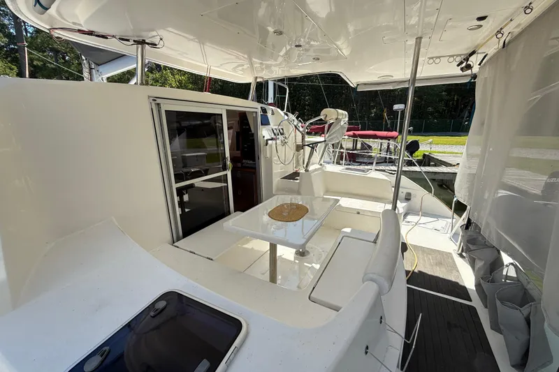 Slide: The Image of 2010 Leopard 38 catamaran cockpit with seating, table, and helm station. - 20