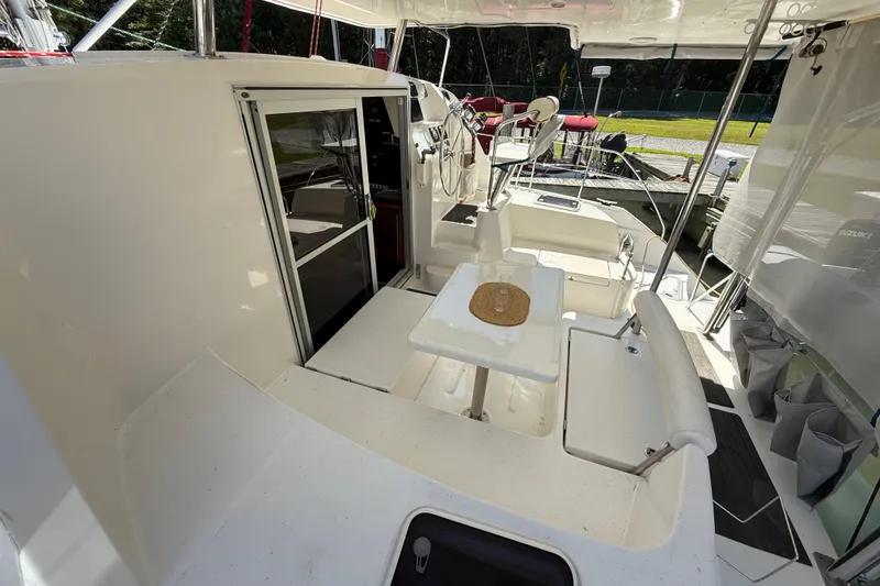 Slide: The Image of 2010 Leopard 38 catamaran cockpit with seating, table, and helm station. - 21