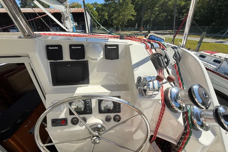 Slide: The Image of Helm of 2010 Leopard 38 catamaran with navigation instruments and steering wheel. - 26