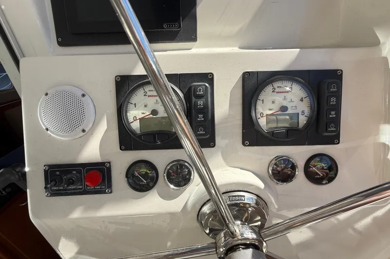 Slide: The Image of Control panel of a 2010 Leopard 38 yacht with gauges and steering wheel. - 27