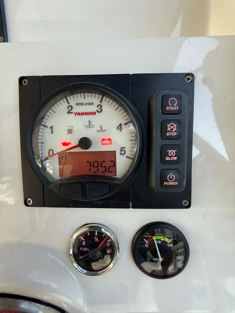 Slide: The Image of Yanmar engine control panel on a 2010 Leopard 38, showing RPM, fuel, and voltage gauges. - 28