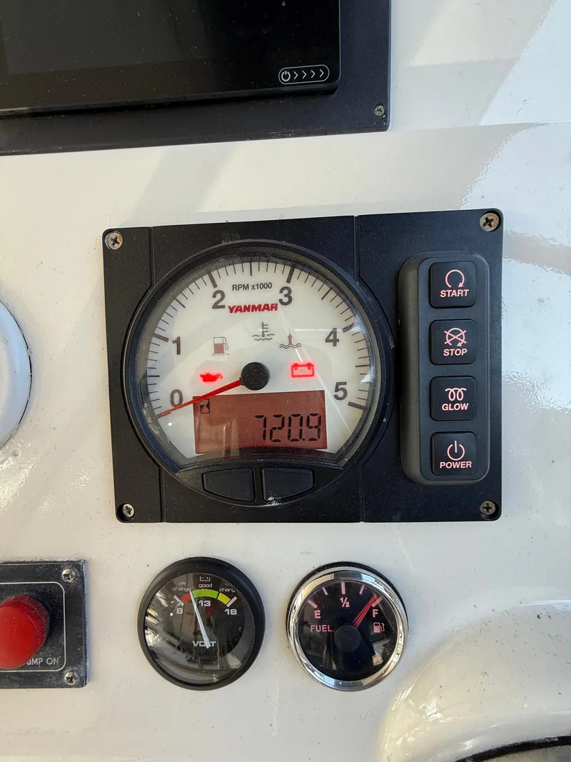 Slide: The Image of Control panel of a 2010 Leopard 38 with Yanmar RPM gauge and buttons. - 29