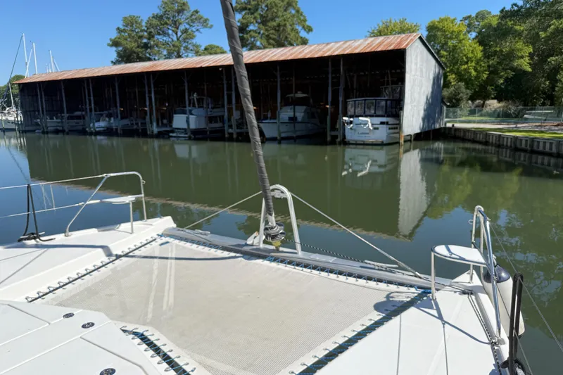 Slide: The Image of Catamaran Leopard 38 docked near a boathouse, calm water, sunny day, 2010 model. - 33
