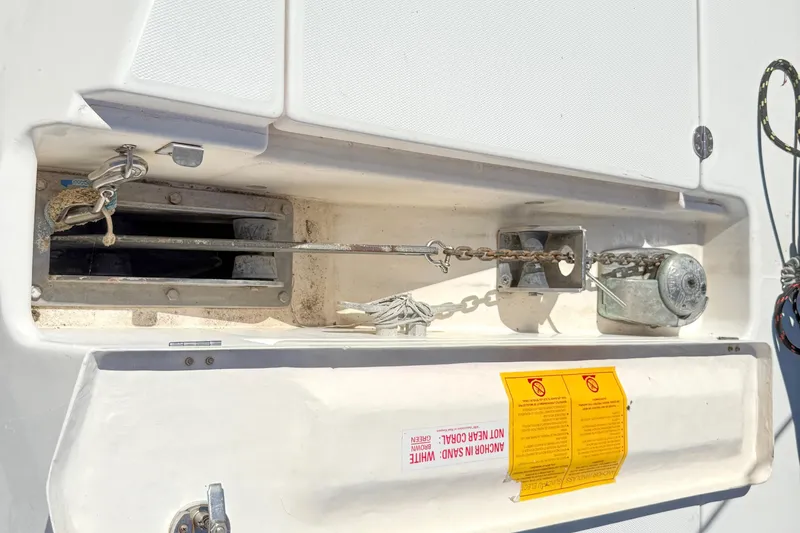 Slide: The Image of Anchor chain mechanism on a 2010 Leopard 38 catamaran, featuring safety warnings and equipment. - 34