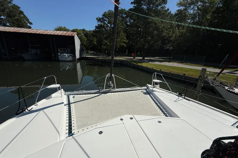 Slide: The Image of 2010 Leopard 38 catamaran docked in a serene marina setting. - 35
