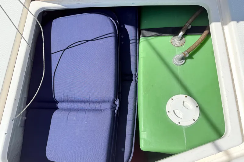 Slide: The Image of Storage compartment on a 2010 Leopard 38 boat with cushions and green tank. - 38