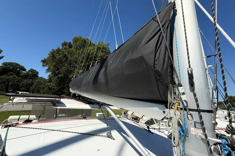 Slide: The Image of 2010 Leopard 38 sailboat with covered mainsail, docked under clear blue sky. - 41