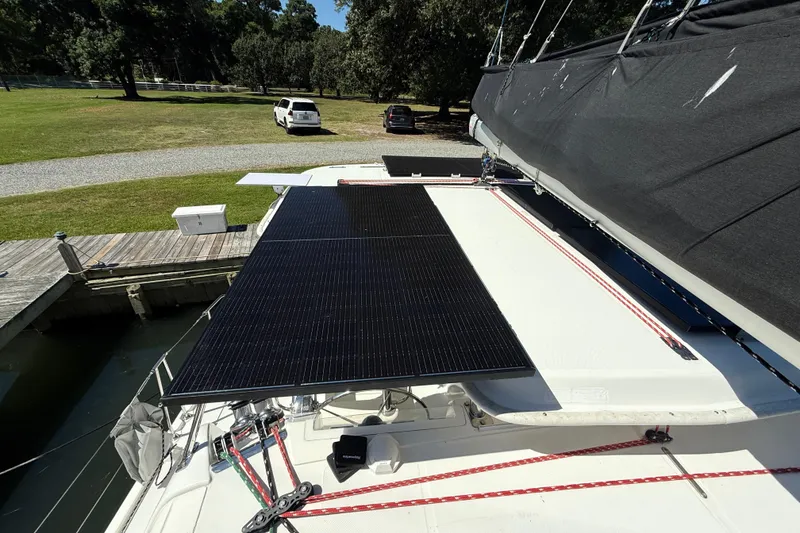 Slide: The Image of Solar panels on a 2010 Leopard 38 catamaran docked near a grassy area. - 44