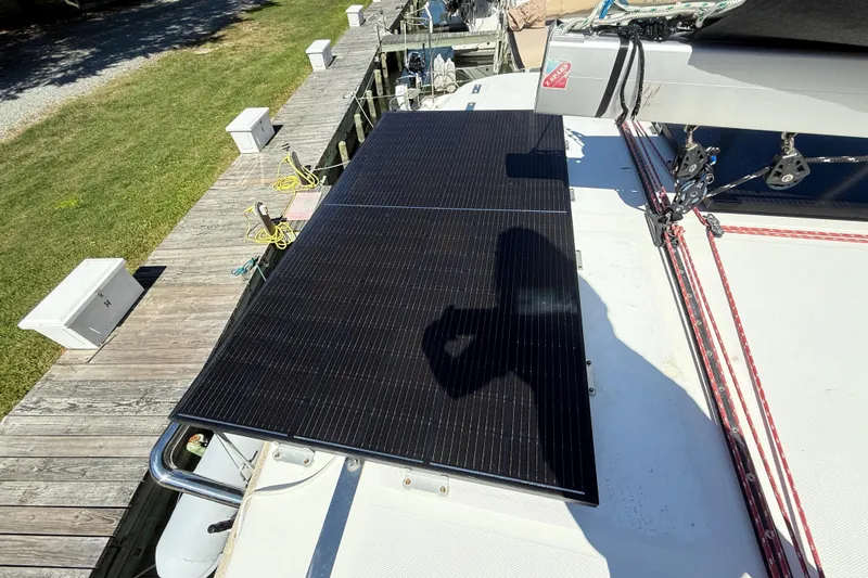 Slide: The Image of Solar panel on Leopard 38 catamaran, docked, with visible rigging and green lawn nearby. - 45