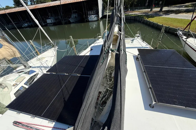 Slide: The Image of 2010 Leopard 38 catamaran with solar panels docked at marina. - 46
