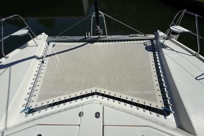 Slide: The Image of 2010 Leopard 38 catamaran trampoline deck, featuring sturdy netting and sleek design. - 47