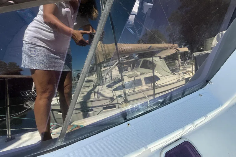 Slide: The Image of Reflection on Leopard 38 sailboat window, showing a person taking a photo, 2010 model. - 48