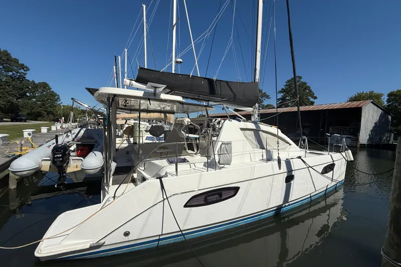 Slide: The Image of 2010 Leopard 38 catamaran docked at marina under clear blue sky. - 5