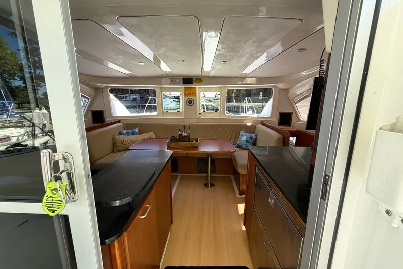 Slide: The Image of Interior of 2010 Leopard 38 catamaran with cozy seating and modern kitchen area. - 52