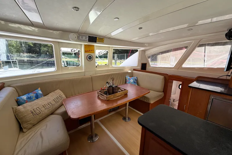 Slide: The Image of Interior of 2010 Leopard 38 catamaran with cozy seating and dining area. - 56