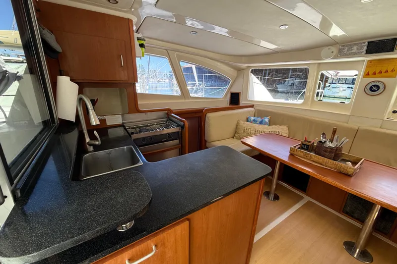 Slide: The Image of Interior of 2010 Leopard 38 catamaran with kitchen and seating area. - 57