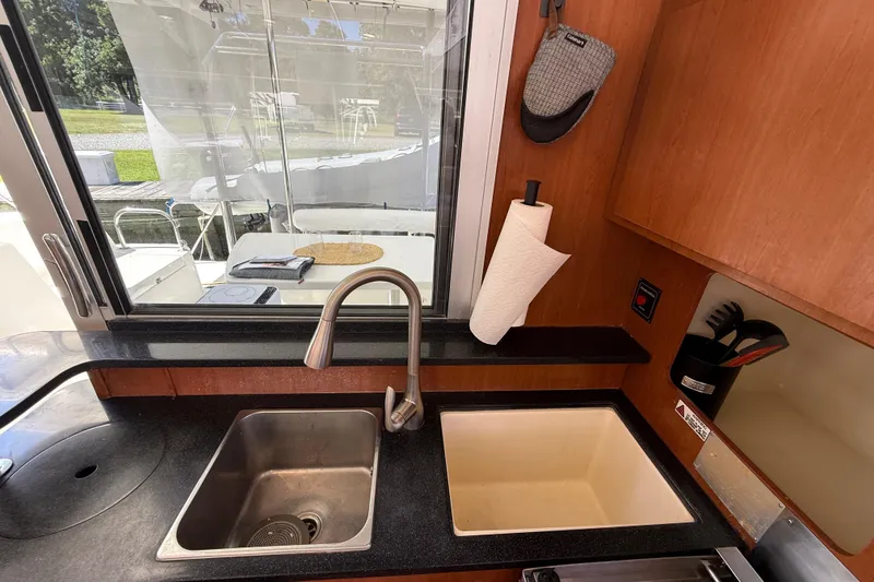 Slide: The Image of Galley kitchen in 2010 Leopard 38 yacht with dual sinks and window view. - 66