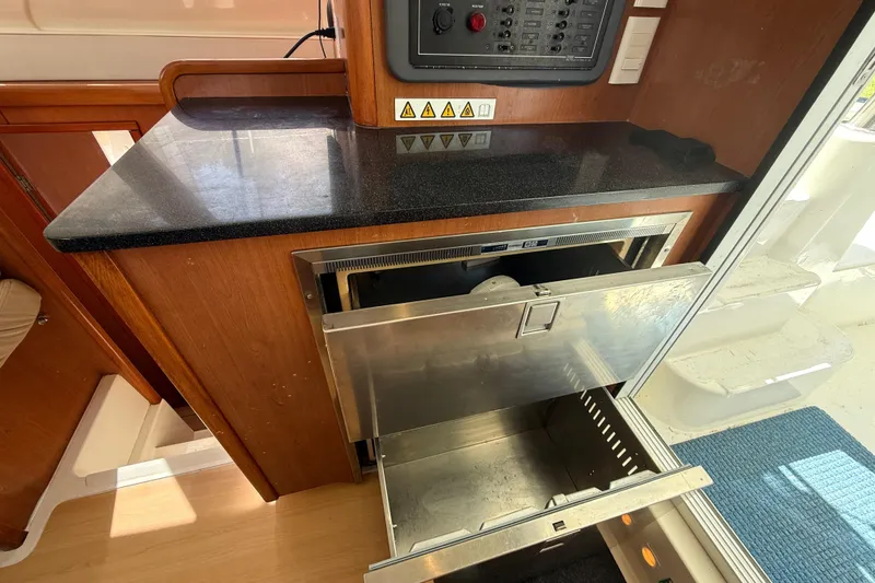 Slide: The Image of 2010 Leopard 38 yacht interior with open stainless steel drawer and control panel. - 67