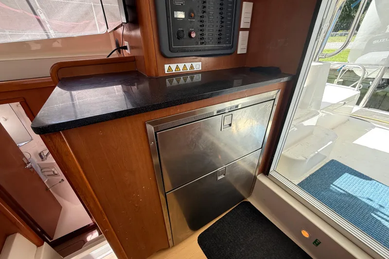 Slide: The Image of Interior of 2010 Leopard 38 yacht with stainless steel appliances and control panel. - 68