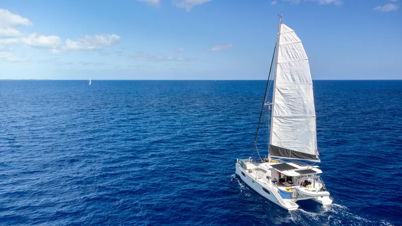 Slide: The Image of Sailing catamaran Leopard 38, 2010 model, cruising on open blue ocean under clear sky. - 7