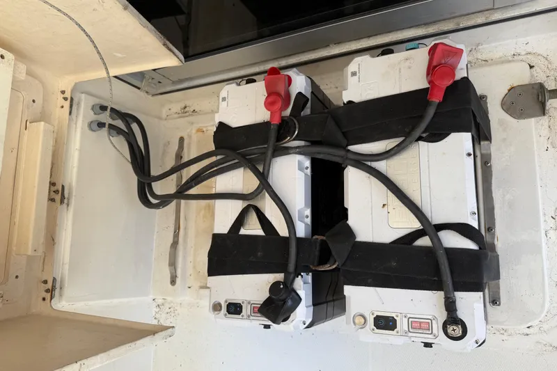 Slide: The Image of Battery compartment of a 2010 Leopard 38 with secured cables and connectors. - 70