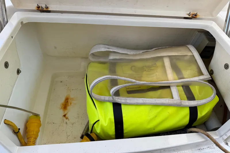 Slide: The Image of Storage compartment on a 2010 Leopard 38 boat with yellow bag and cables. - 72