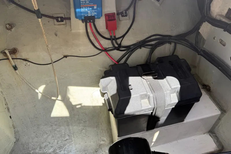 Slide: The Image of Battery compartment of a 2010 Leopard 38 boat with wiring and charger. - 74