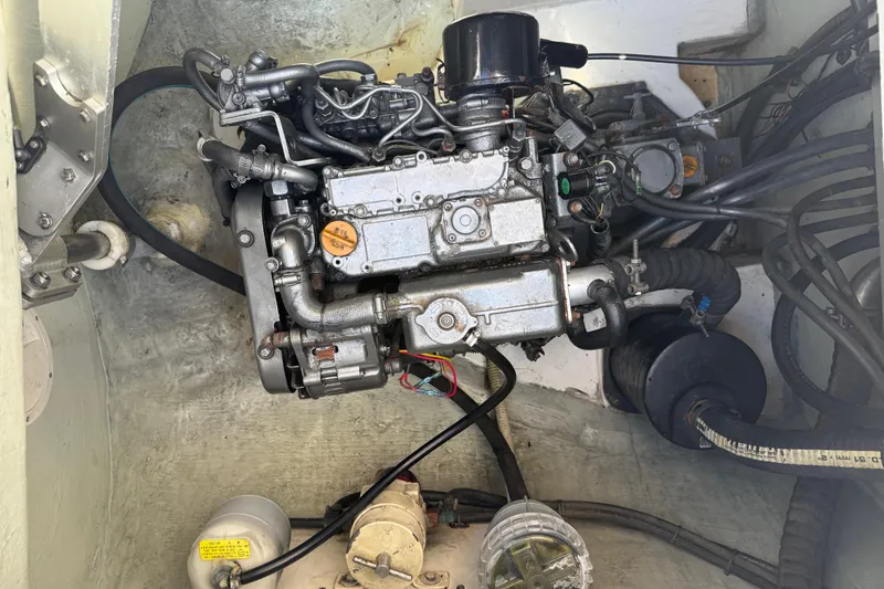 Slide: The Image of Engine compartment of a 2010 Leopard 38, showcasing mechanical components and wiring. - 75